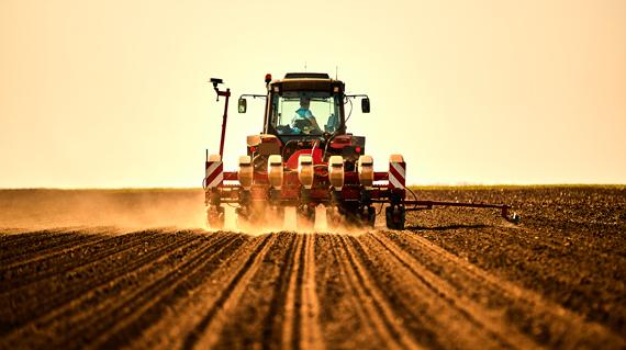 farmer-in-tractor-seeding-soybean-crops-at-arable-field