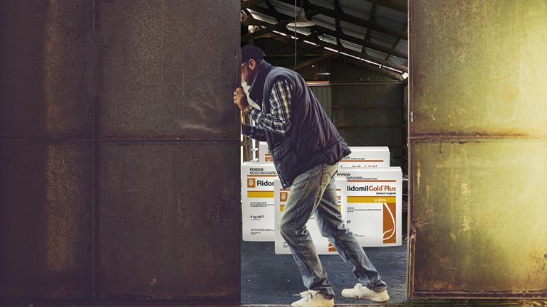 man pushing open gate