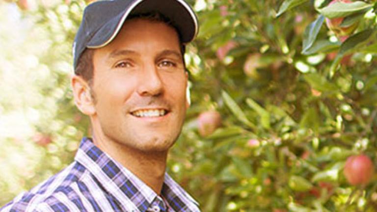 Orchard farmer smiling 