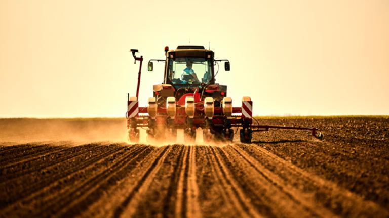 farmer-in-tractor-seeding-soybean-crops-at-arable-field
