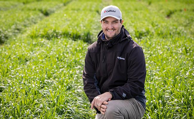 Syngenta ANZ Herbicide Product Lead Owen Langley kneeling in field